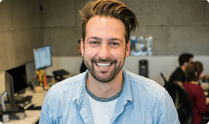 Smiling tutor in a video call on a computer screen